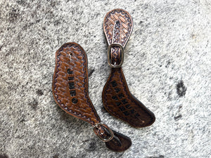 Hand tooled and painted basket weave spur straps.