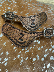 Hand tooled and painted Custom Brand spur straps basketweave.